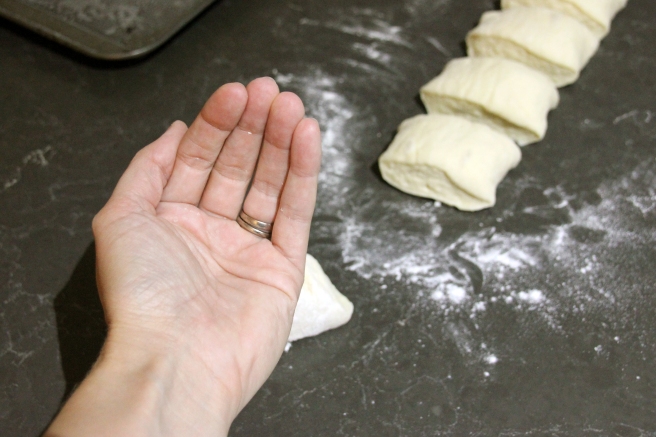 Cupping your hand to roll the dough